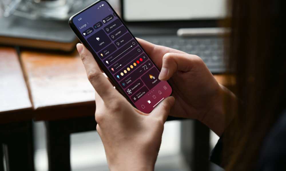 <p>A person using a smartphone app to control smart home lighting and scenes.</p>